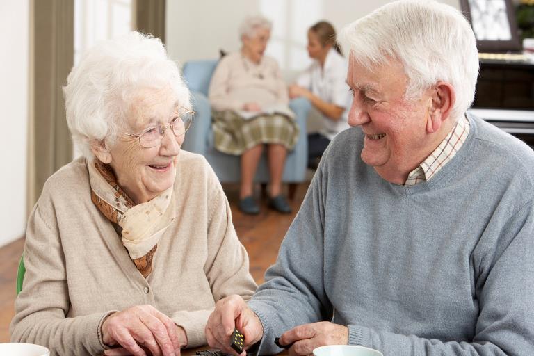 Two elderly playing a game at a nursing home