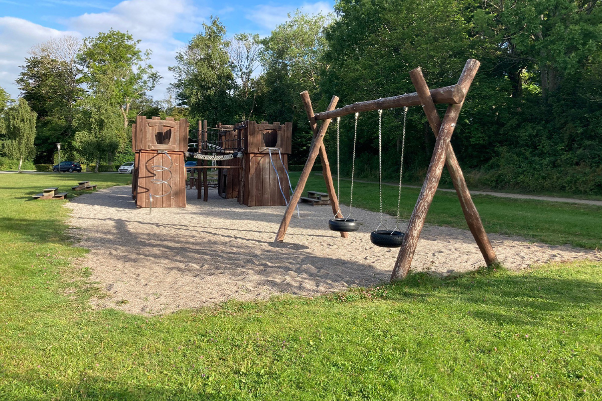 Swings and playhouse at playground in Maribo